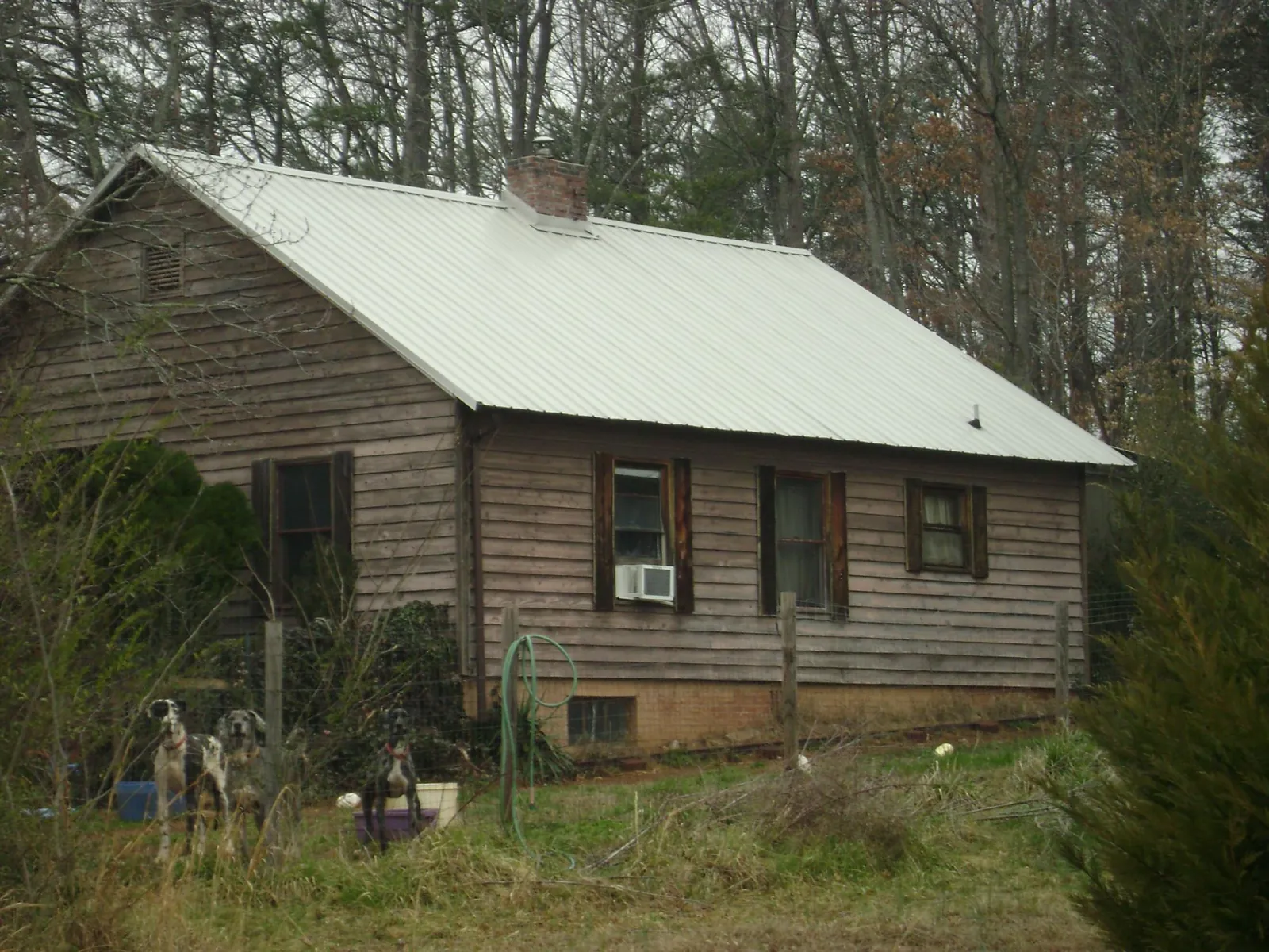White metal roof on an old wood sided farmhouse, from a Metal Roof Installation job in Buchanan
